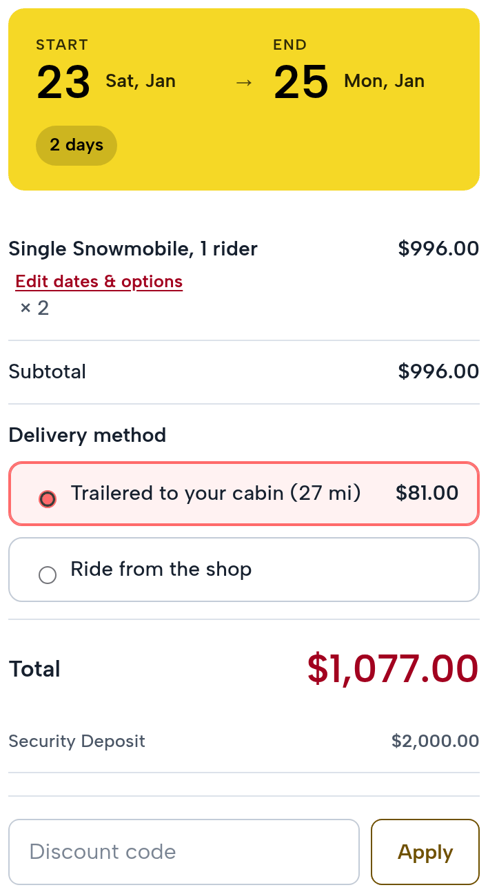 The checkout summary: two Single Snowmobiles, January 23 to 25, 2027, $996.00; Trailered to your cabin (27 mi) $81.00 or Ride from the shop; total $1,077.00; security deposit $2,000.00